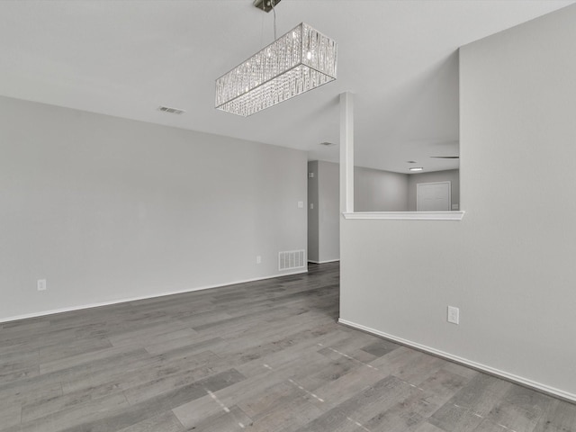 401 Iron Ore Trl, Fort Worth, TX 76131 - spare room featuring a chandelier, wood finished floors, and baseboards