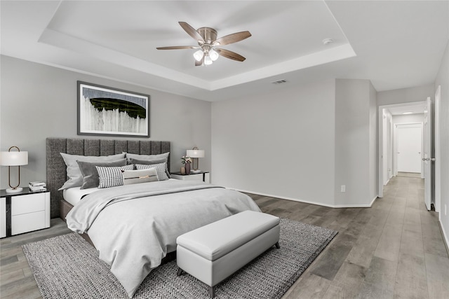 401 Iron Ore Trl, Fort Worth, TX 76131 - bedroom with a tray ceiling, wood finished floors, baseboards, and a ceiling fan