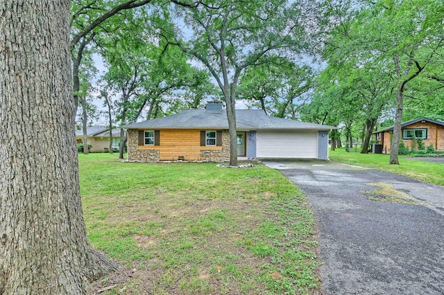 912 Kiowa Dr W, Lake Kiowa, TX 76240 - ranch-style house with asphalt driveway, a garage, stone siding, and a front lawn