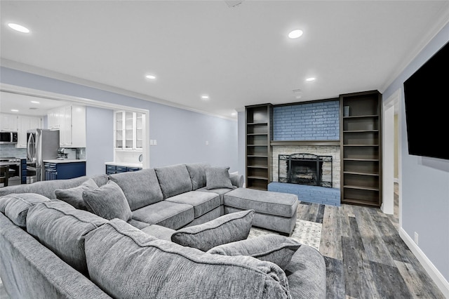 912 Kiowa Dr W, Lake Kiowa, TX 76240 - living area featuring wood finished floors, recessed lighting, a brick fireplace, crown molding, and baseboards