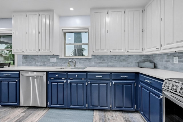 912 Kiowa Dr W, Lake Kiowa, TX 76240 - kitchen with appliances with stainless steel finishes, blue cabinetry, light countertops, white cabinets, and recessed lighting