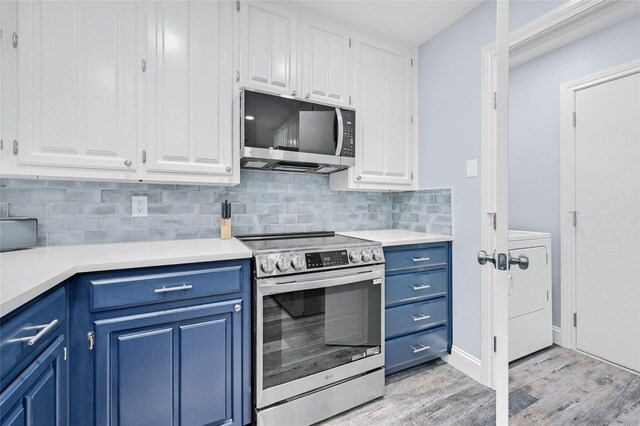 912 Kiowa Dr W, Lake Kiowa, TX 76240 - kitchen with stainless steel appliances, blue cabinetry, white cabinetry, and washer / dryer