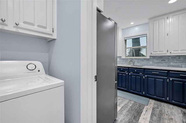 912 Kiowa Dr W, Lake Kiowa, TX 76240 - clothes washing area featuring washer / dryer, cabinet space, light wood-style floors, and recessed lighting