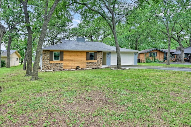 912 Kiowa Dr W, Lake Kiowa, TX 76240 - view of front facade featuring driveway, stone siding, an attached garage, a chimney, and a front lawn