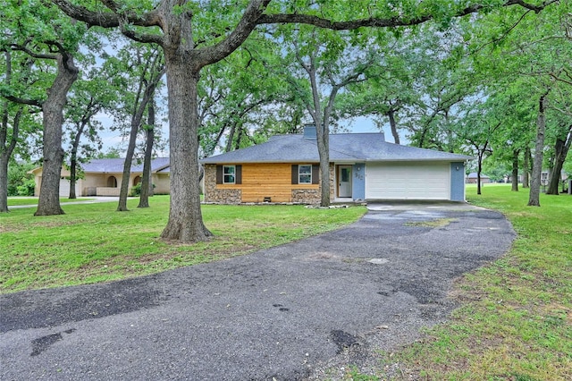 912 Kiowa Dr W, Lake Kiowa, TX 76240 - view of front of home with driveway, a garage, a front yard, a chimney, and stone siding