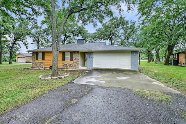 912 Kiowa Dr W, Lake Kiowa, TX 76240 - view of front of home featuring an attached garage, stone siding, asphalt driveway, a front yard, and a chimney