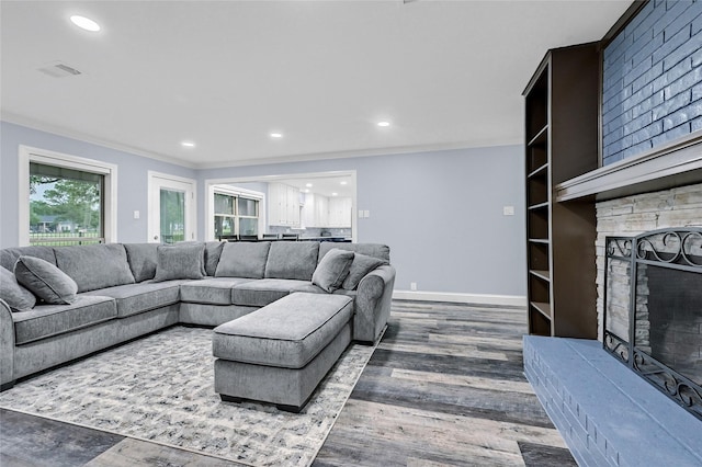 912 Kiowa Dr W, Lake Kiowa, TX 76240 - living room featuring a stone fireplace, wood finished floors, recessed lighting, crown molding, and baseboards