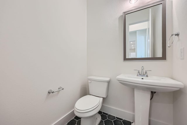 180 Shoreview Dr, Rhome, TX 76078 - bathroom with tile patterned floors, baseboards, and toilet