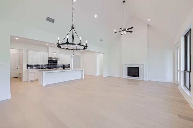 180 Shoreview Dr, Rhome, TX 76078 - kitchen featuring open floor plan, white cabinets, recessed lighting, a chandelier, and light wood-style floors