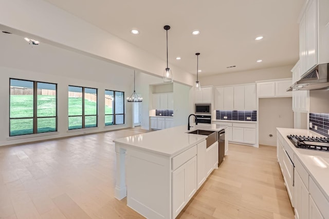 180 Shoreview Dr, Rhome, TX 76078 - kitchen with a sink, stainless steel appliances, tasteful backsplash, open floor plan, and white cabinetry