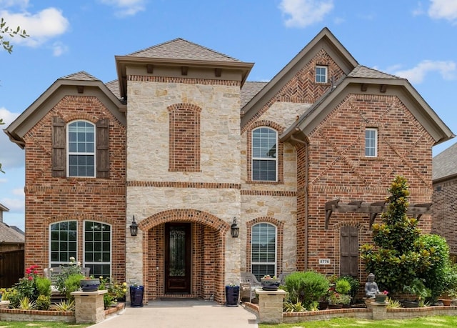 5776 Civetta Ct, Frisco, TX 75035 - french country home with stone siding, brick siding, and a shingled roof