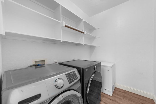 5776 Civetta Ct, Frisco, TX 75035 - laundry room with washer and dryer, light wood-type flooring, and baseboards