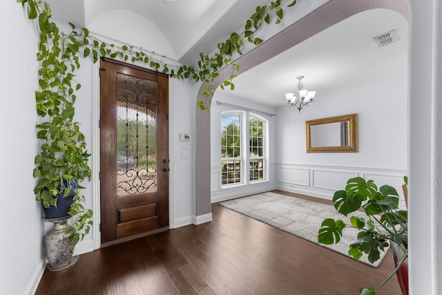 5776 Civetta Ct, Frisco, TX 75035 - foyer entrance with wood finished floors, a chandelier, arched walkways, and baseboards