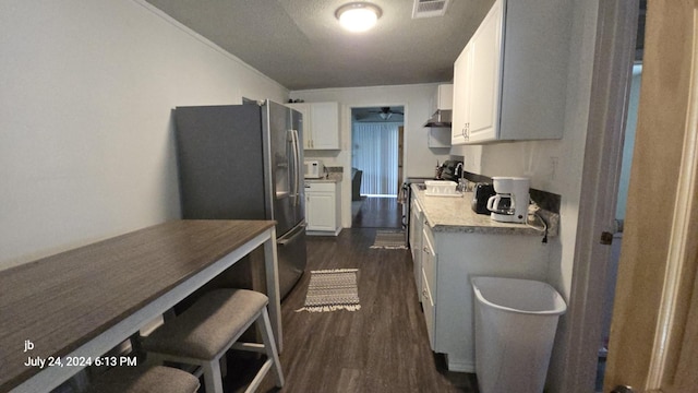8278 Circle Dr, Kemp, TX 75143 - kitchen featuring appliances with stainless steel finishes, dark wood finished floors, white cabinetry, and ceiling fan