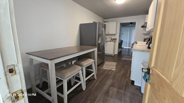 8278 Circle Dr, Kemp, TX 75143 - kitchen featuring stainless steel refrigerator with ice dispenser, white cabinets, dark wood-style flooring, light countertops, and a ceiling fan