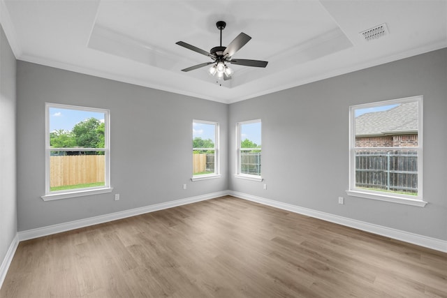 313 Crye Cir, Robinson, TX 76706 - unfurnished room featuring a tray ceiling, ornamental molding, wood finished floors, baseboards, and a ceiling fan