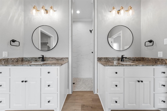 313 Crye Cir, Robinson, TX 76706 - full bathroom featuring wood finished floors, two vanities, and a walk in shower