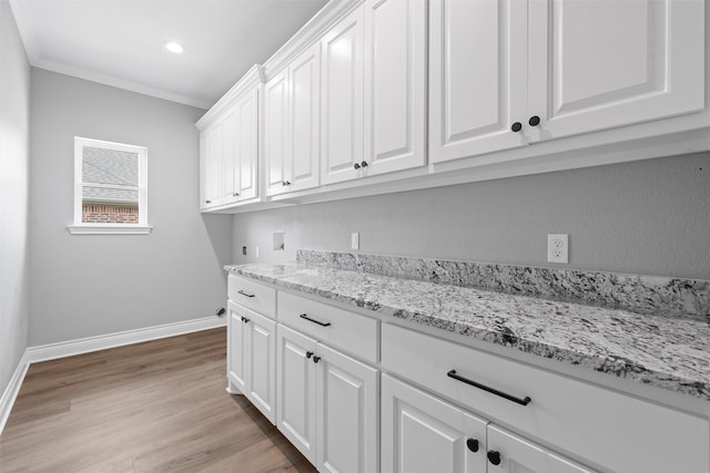 313 Crye Cir, Robinson, TX 76706 - laundry room with cabinet space, washer hookup, baseboards, light wood finished floors, and ornamental molding