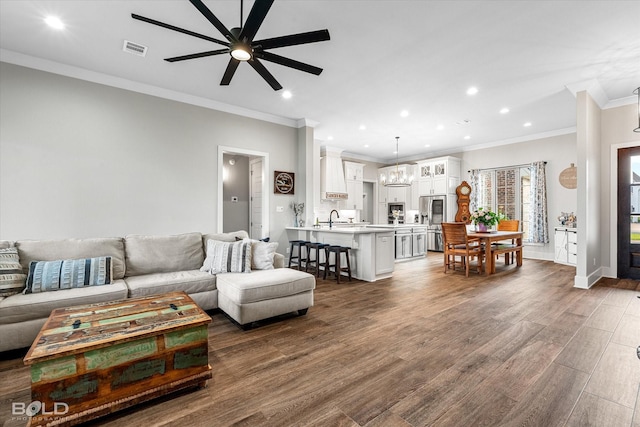 267 Poydras Ave, Bossier City, LA 71111 - living room featuring a ceiling fan, recessed lighting, ornamental molding, dark wood-style flooring, and baseboards