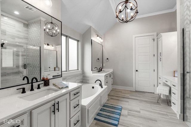 267 Poydras Ave, Bossier City, LA 71111 - bathroom featuring a chandelier, a stall shower, a bath, two vanities, and ornamental molding
