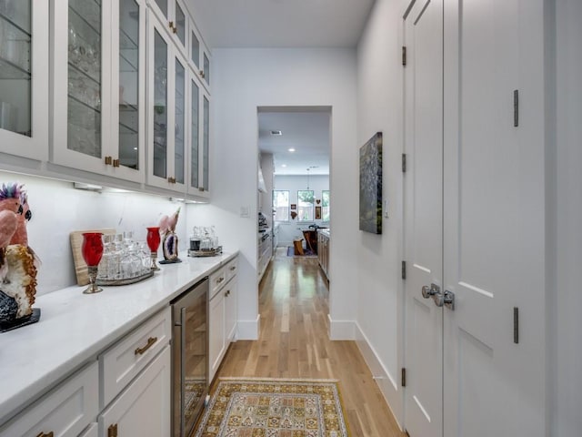 5019 Lark Ln, Dallas, TX 75209 - bar with wine cooler and light wood finished floors