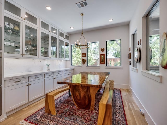 5019 Lark Ln, Dallas, TX 75209 - dining area featuring healthy amount of natural light, a chandelier, light wood-style floors, and recessed lighting