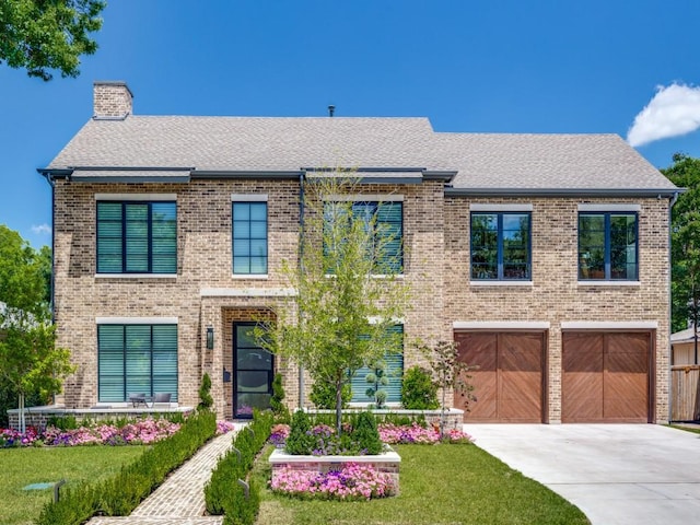 5019 Lark Ln, Dallas, TX 75209 - view of front of property featuring a garage, concrete driveway, a chimney, brick siding, and roof with shingles