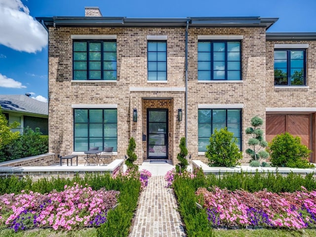 5019 Lark Ln, Dallas, TX 75209 - view of front of house featuring brick siding, a chimney, and a patio area