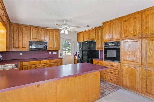 211 Partners Rd, Woodway, TX 76712 - kitchen with black appliances, a sink, a ceiling fan, a peninsula, and dark countertops