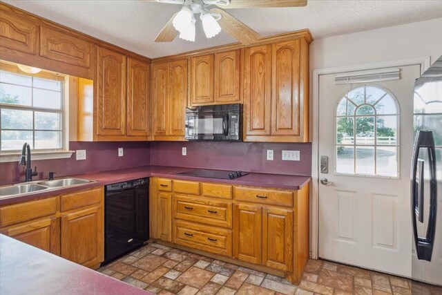 211 Partners Rd, Woodway, TX 76712 - kitchen featuring black appliances, a sink, plenty of natural light, and brown cabinetry