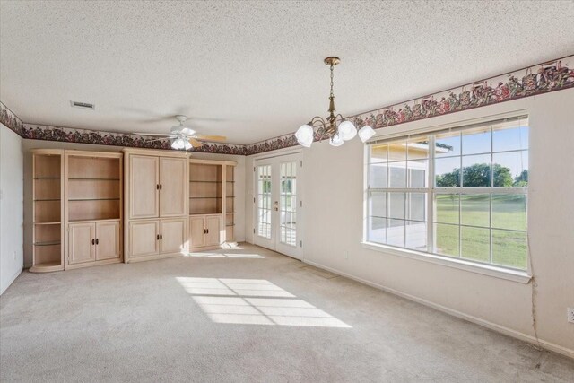 211 Partners Rd, Woodway, TX 76712 - unfurnished dining area featuring a textured ceiling, plenty of natural light, french doors, and light colored carpet