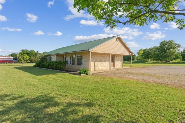 211 Partners Rd, Woodway, TX 76712 - view of side of property with stone siding, a lawn, metal roof, and driveway