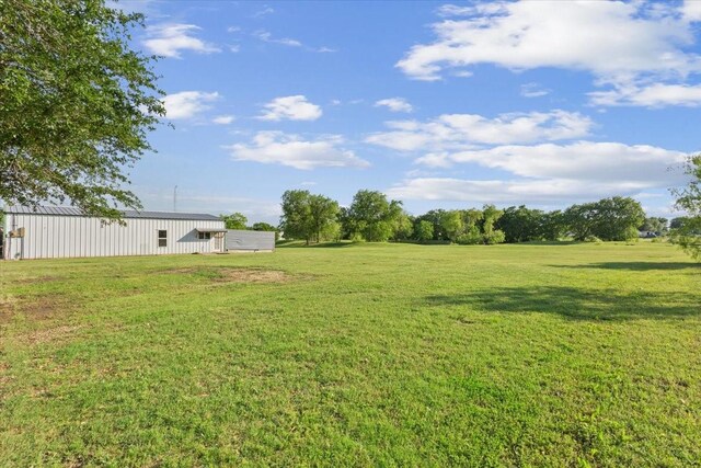 211 Partners Rd, Woodway, TX 76712 - view of green lawn featuring a pole building and an outdoor structure