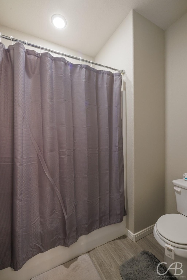 6833 Inverness St, Abilene, TX 79606 - full bath with wood finished floors, baseboards, and toilet