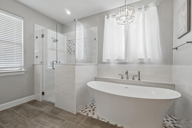 7747 Barber Ranch Rd, Fort Worth, TX 76126 - full bathroom with a stall shower, a freestanding bath, a chandelier, tile patterned flooring, and tile walls