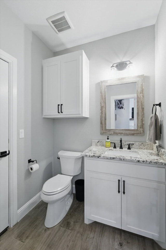 7747 Barber Ranch Rd, Fort Worth, TX 76126 - bathroom featuring wood finished floors, toilet, baseboards, and vanity