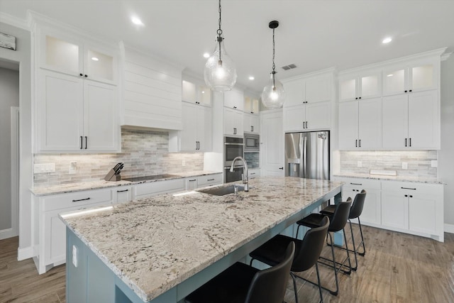 7747 Barber Ranch Rd, Fort Worth, TX 76126 - kitchen featuring appliances with stainless steel finishes, a sink, light wood-type flooring, recessed lighting, and backsplash