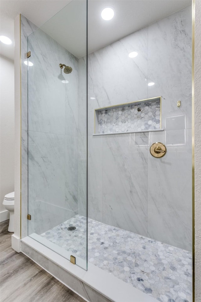 7209 Coventry Cir, North Richland Hills, TX 76182 - bathroom with wood finished floors, a marble finish shower, toilet, and recessed lighting