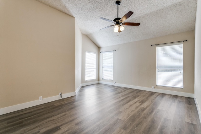 7209 Coventry Cir, North Richland Hills, TX 76182 - unfurnished room with a textured ceiling, lofted ceiling, a ceiling fan, dark wood-type flooring, and baseboards