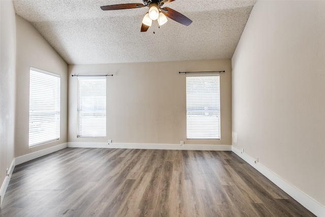 7209 Coventry Cir, North Richland Hills, TX 76182 - empty room featuring a textured ceiling, vaulted ceiling, ceiling fan, wood finished floors, and baseboards
