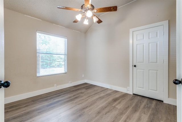 7209 Coventry Cir, North Richland Hills, TX 76182 - empty room featuring lofted ceiling, wood finished floors, a ceiling fan, and baseboards