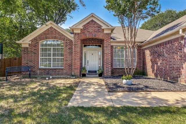 7209 Coventry Cir, North Richland Hills, TX 76182 - view of exterior entry featuring brick siding and fence