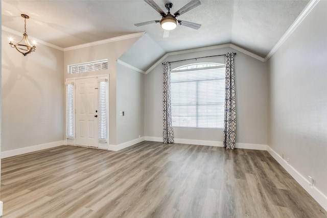 7209 Coventry Cir, North Richland Hills, TX 76182 - foyer entrance featuring wood finished floors, lofted ceiling, a ceiling fan, a chandelier, and baseboards