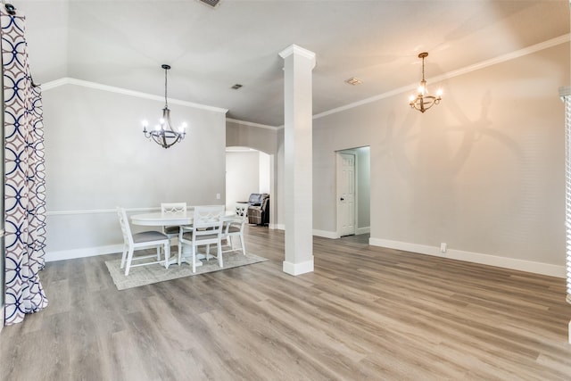 7209 Coventry Cir, North Richland Hills, TX 76182 - dining area with arched walkways, a chandelier, wood finished floors, baseboards, and ornamental molding
