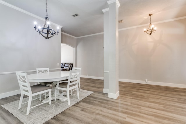7209 Coventry Cir, North Richland Hills, TX 76182 - dining room featuring a chandelier, arched walkways, crown molding, wood finished floors, and baseboards