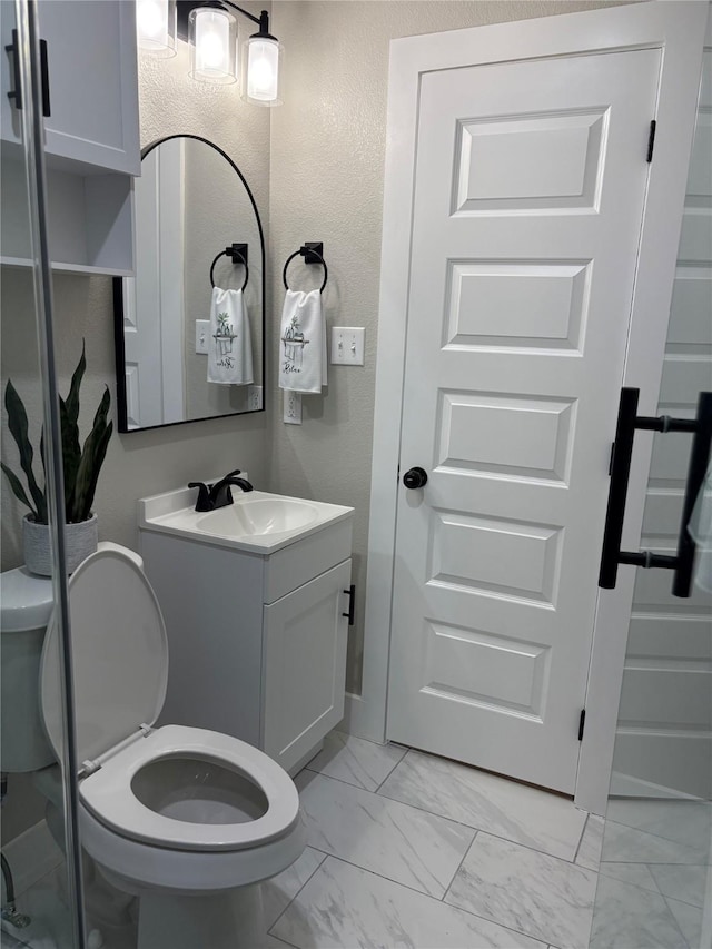 3214 51st St, Dallas, TX 75216 - bathroom with marble finish floors, toilet, and vanity