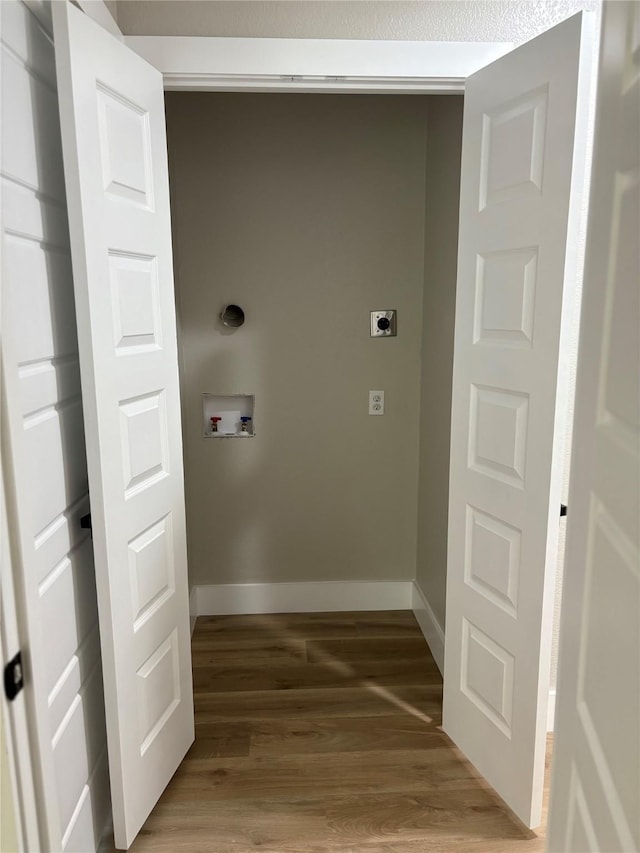 3214 51st St, Dallas, TX 75216 - laundry room featuring electric dryer hookup, hookup for a washing machine, light wood-style flooring, and baseboards