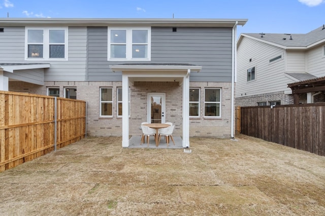 1723 Zachary Ave, Wylie, TX 75098 - rear view of house with brick siding, a fenced backyard, and a patio