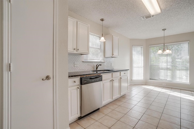 10832 Cobblestone Dr, Benbrook, TX 76126 - kitchen featuring dishwasher, dark countertops, a textured ceiling, a chandelier, and backsplash