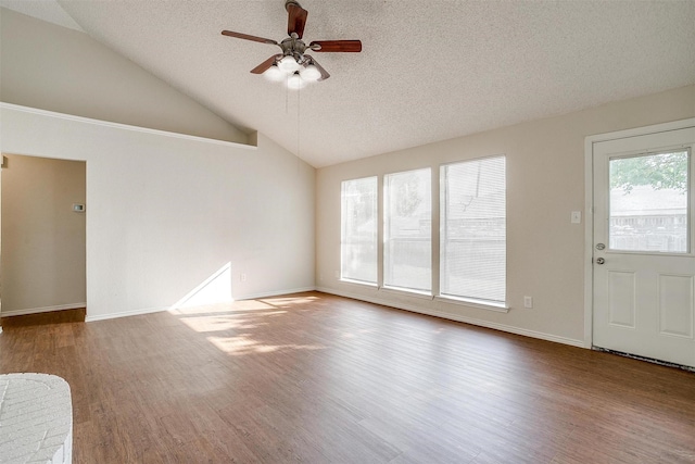 10832 Cobblestone Dr, Benbrook, TX 76126 - unfurnished living room with wood finished floors, ceiling fan, vaulted ceiling, a textured ceiling, and baseboards